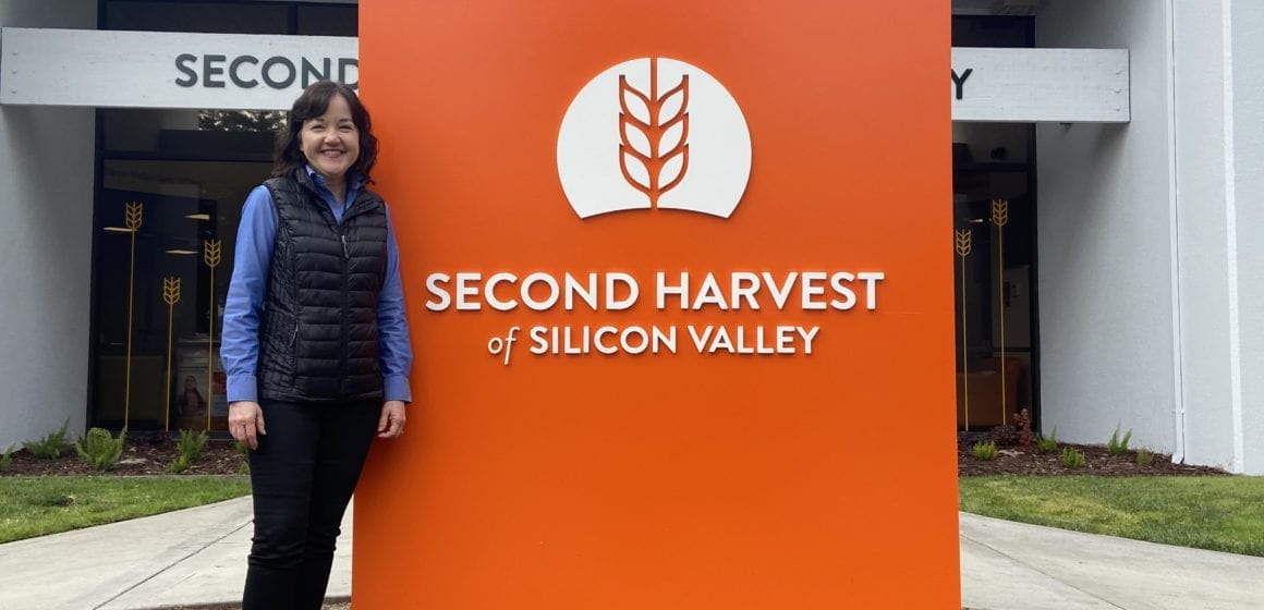 Woman standing next to orange sign