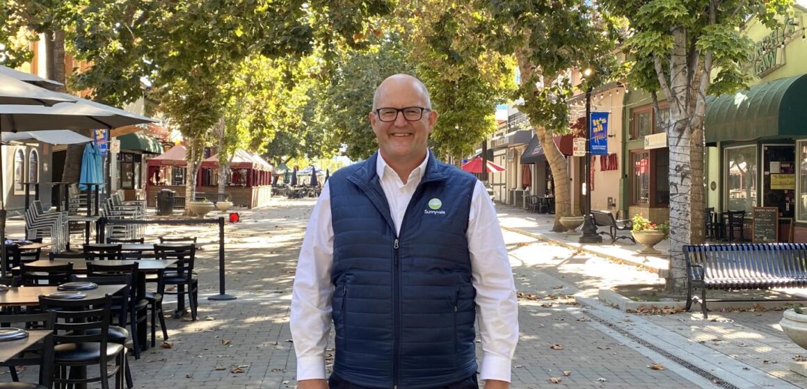 Russ Melton posing in front of Murphy Avenue in Sunnyvale