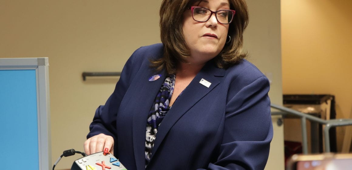 Woman holding new audio voting machine