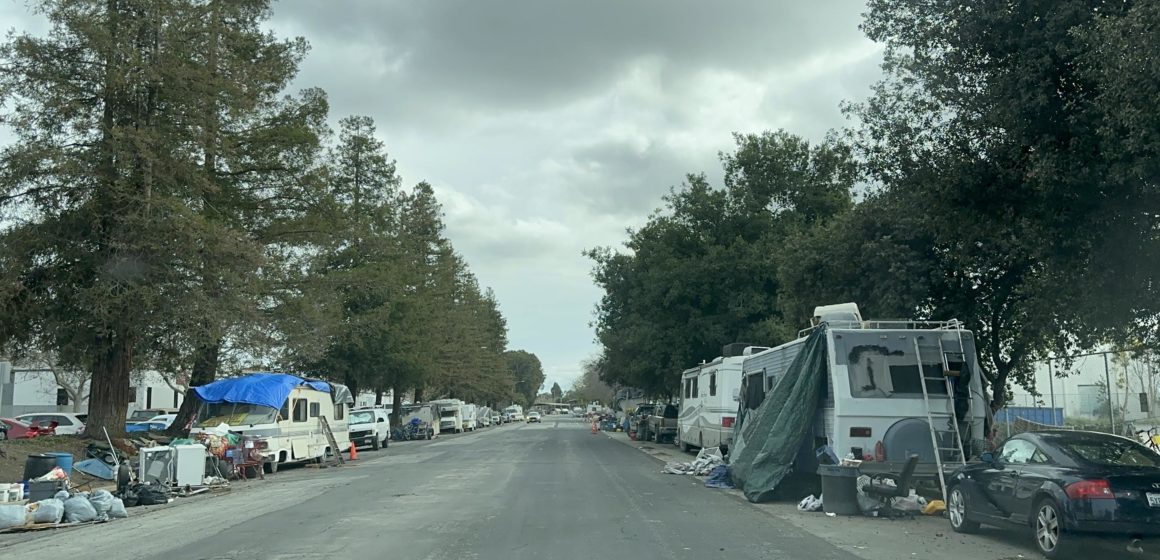 RVs line a street in an industrial area of San Jose