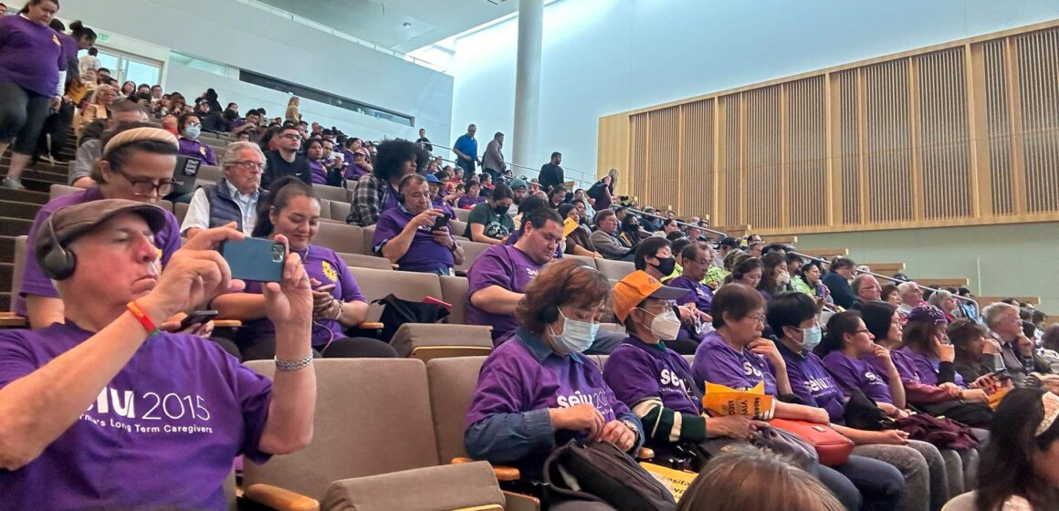 A crowd of people in seats at a San Jose City Council meeting