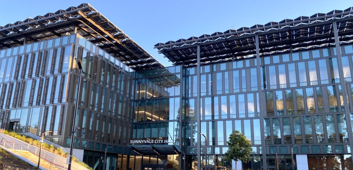 Sunnyvale City Hall, a 4-floor window mostly covered in glass windows with large solar panels on top