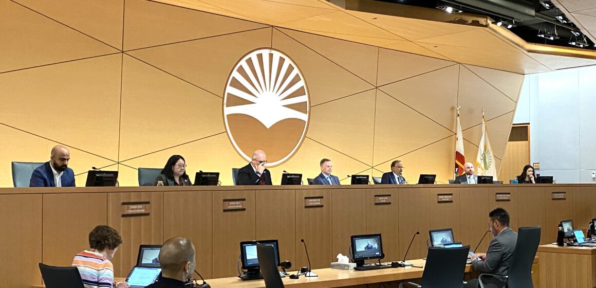 Sunnyvale City Council Chambers with all seven councilmembers sitting at their dais and city employees sitting in front