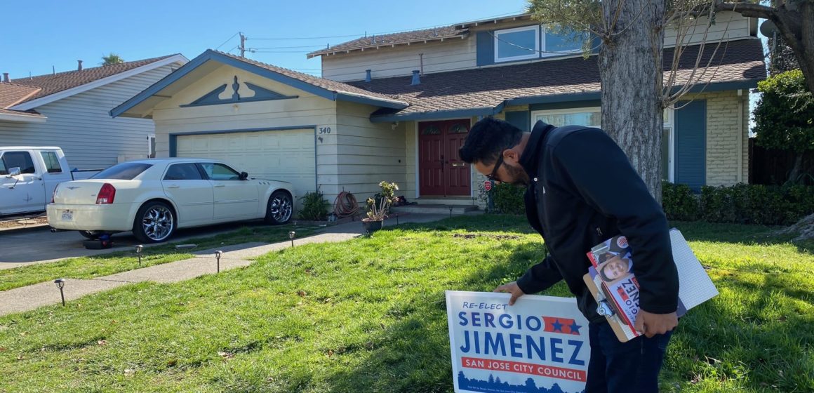 San Jose Councilmember Sergio Jimenez is pictured placing a yard sign in front of a District 2 home. Photo by Nadia Lopez.