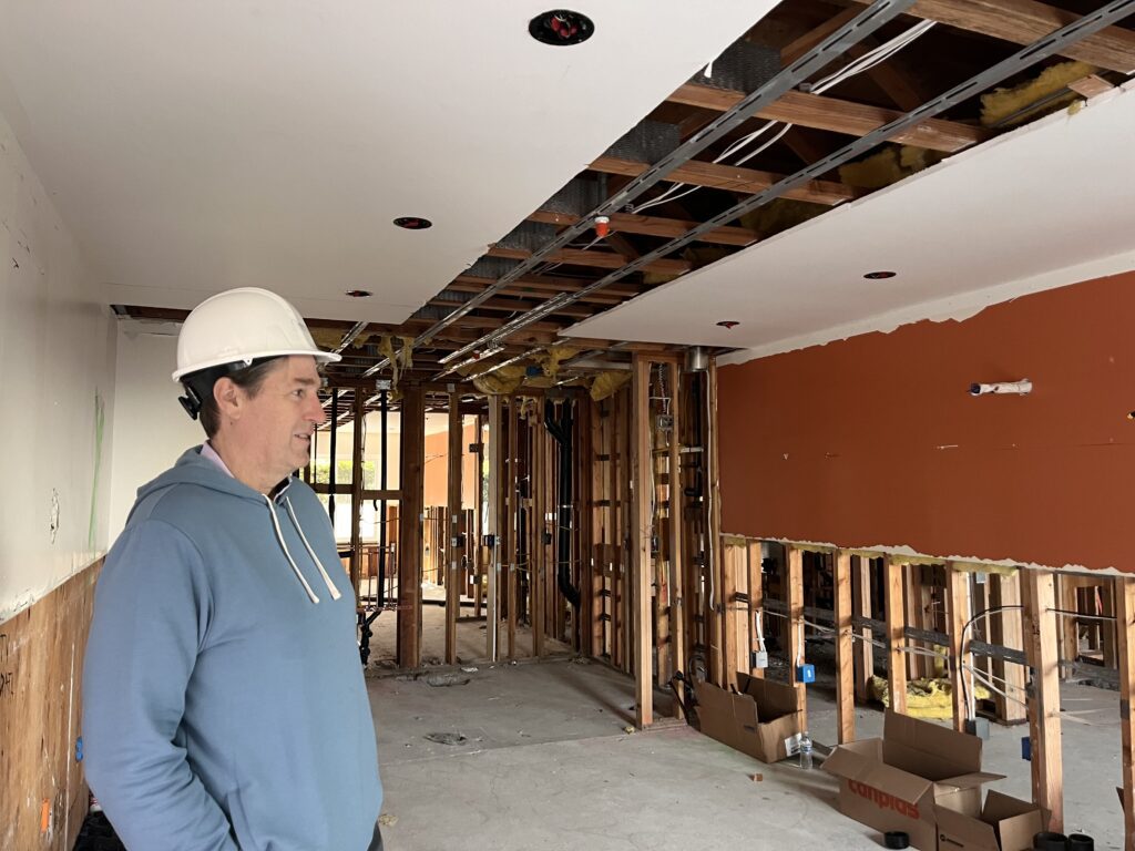 Preston Prince, executive director of the Santa Clara County Housing Authority, reviews construction at the Pavilion Inn. Photo by Lorraine Gabbert.