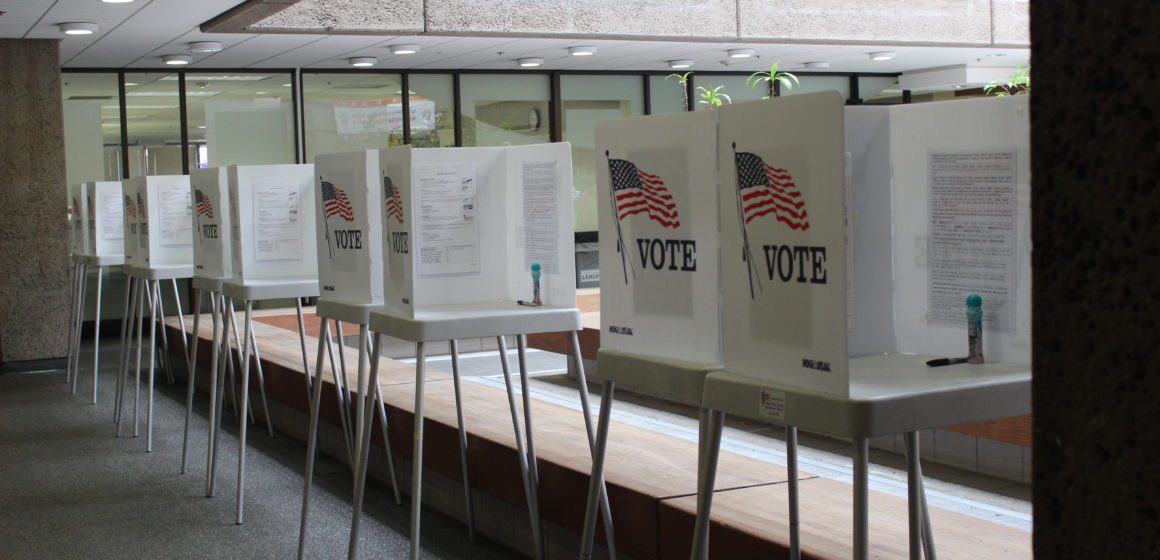 A line of voting booths at the Santa Clara County Registrar of Voters