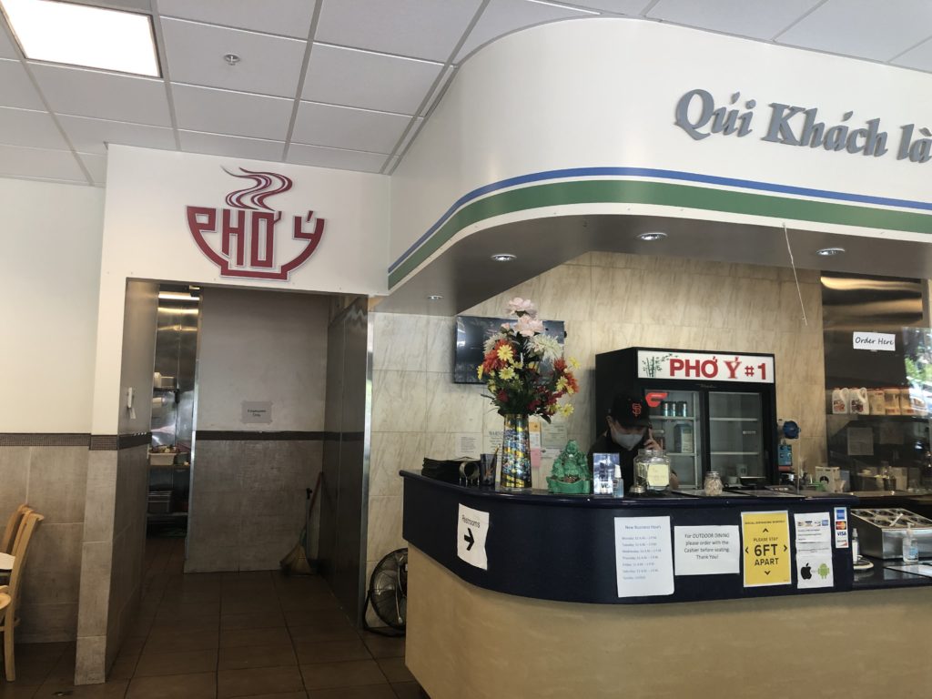 Alex Huynh takes a phone order. His family's restaurant, Pho Y #1 Noodle House in North and East San Jose, opened for indoor dining earlier this year. Photo by Patricia Wei.