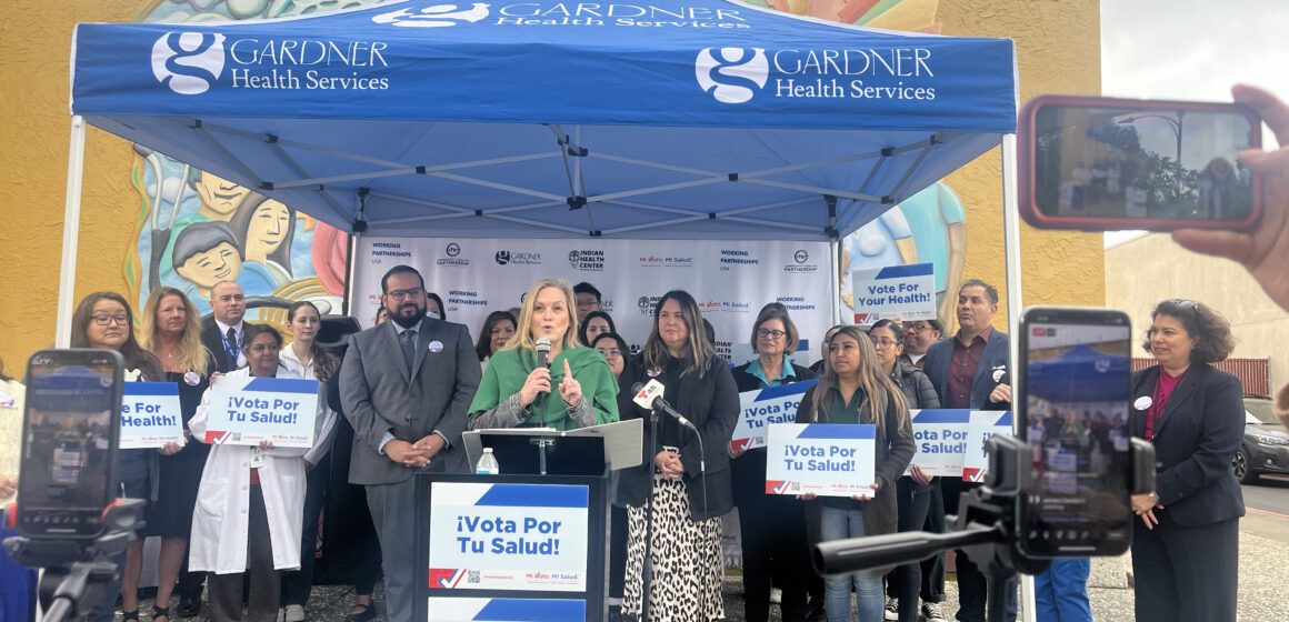 A crowd of people gathered around a podium at a news conference