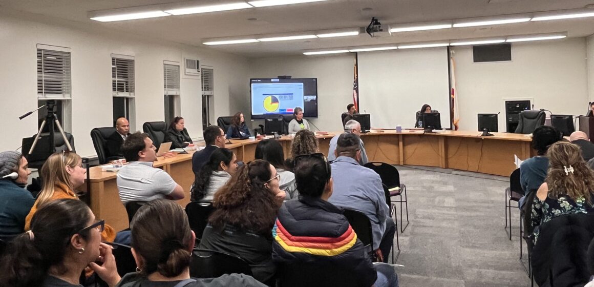 A crowd of people sitting in chairs at an Alum Rock Union School District board meeting in San Jose.