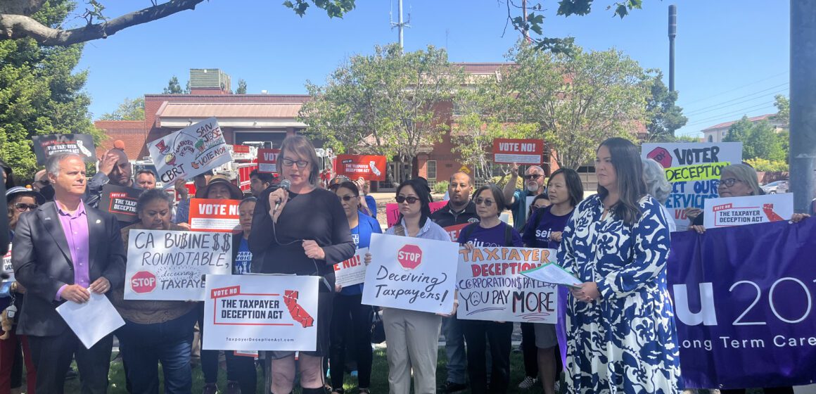 A group of people holding signs outside