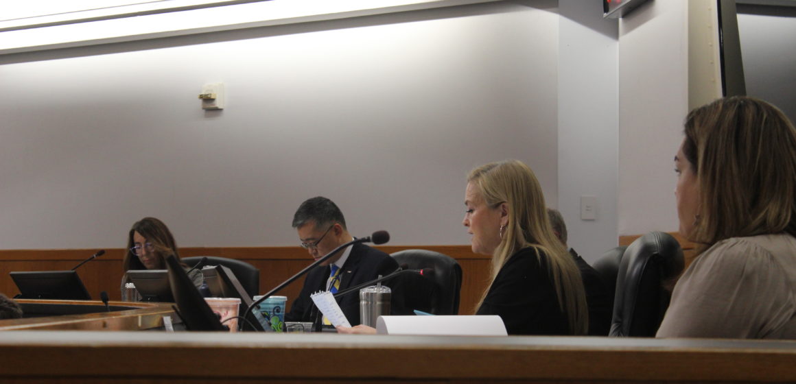 A group of people sitting in chairs at a dais