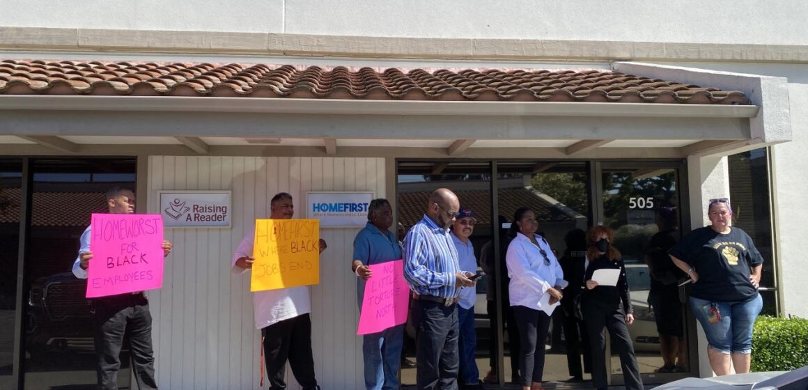 Group of advocates, NAACP representatives, and former HomeFirst employees rallying in front of the HomeFirst offices