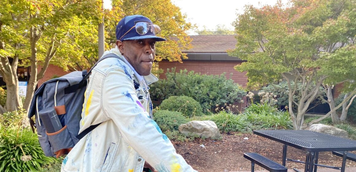 Michael Love with his bike in front of the Sunnyvale Public Library