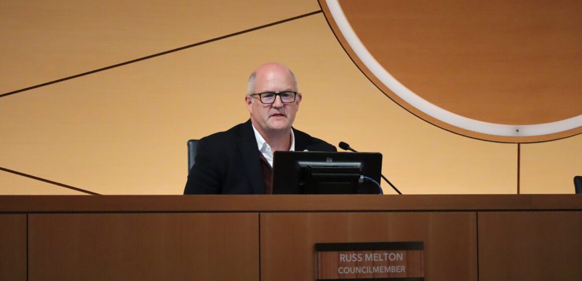 Russ Melton, white-haired man with glasses, sitting in the Sunnyvale City Hall council chambers