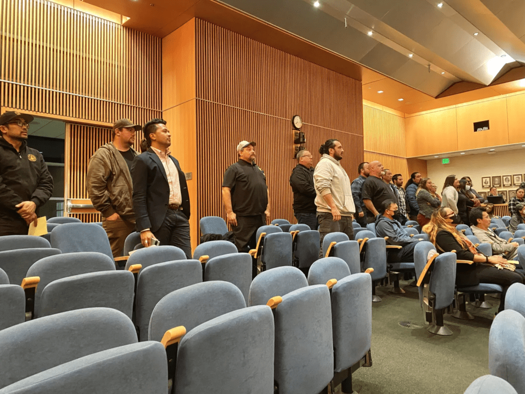 City workers standing in back rows of Milpitas city council chambers