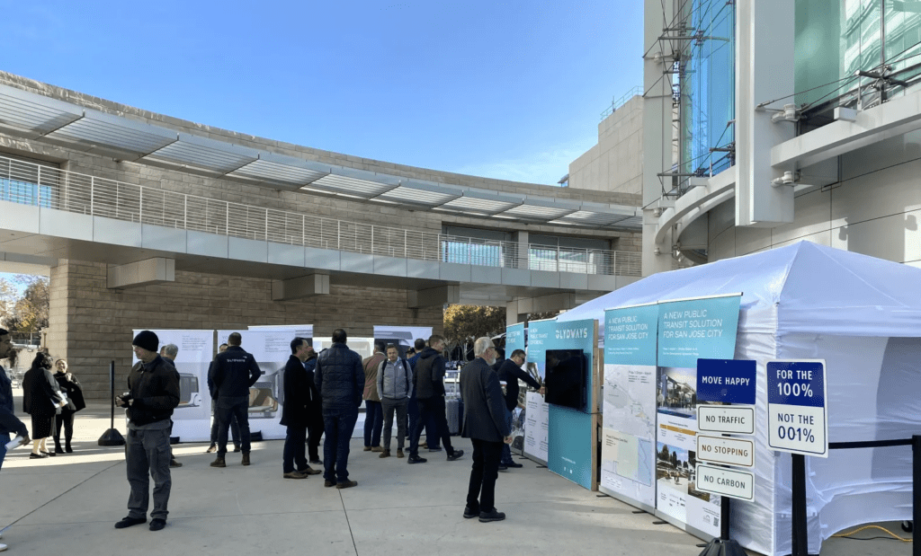 People standing in front of Glydways display outside of San Jose City Hall