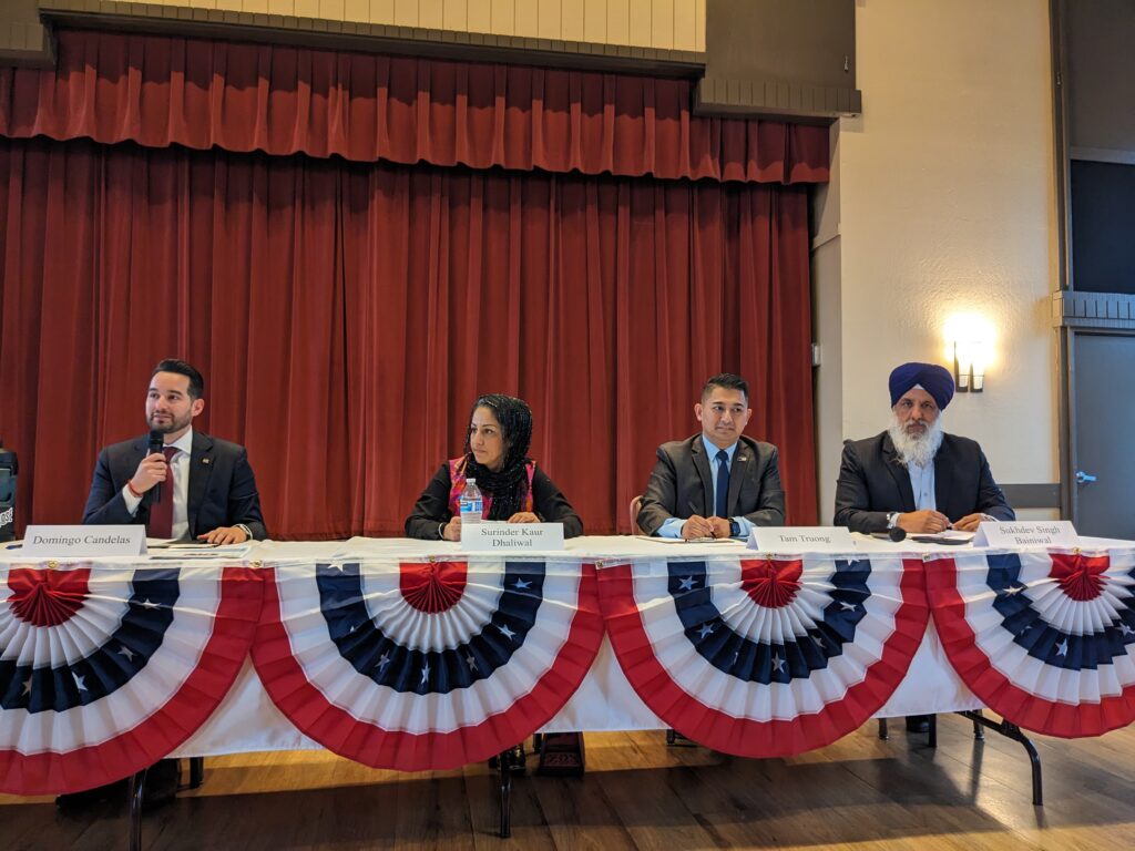 The four candidates for San José City Council District 8 sit at a forum table.