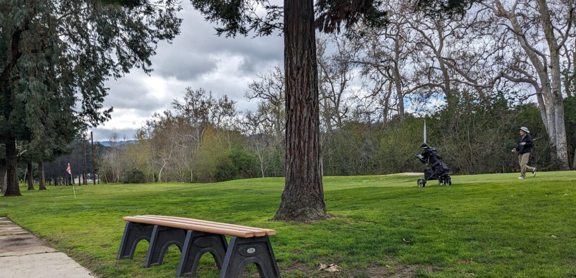 A golfer runs back to their club bag at Cupertino's Blackberry Farm Golf Course, where fees will increase a few dollars in April.