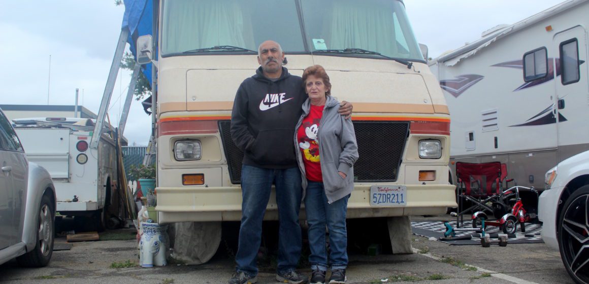 RV park tenants Ram Eisenbarth and Joe Ramirez stand in front of their four-wheeled home at the Santa Clara County Fairgrounds on Sunday. Photo by Vicente Vera.