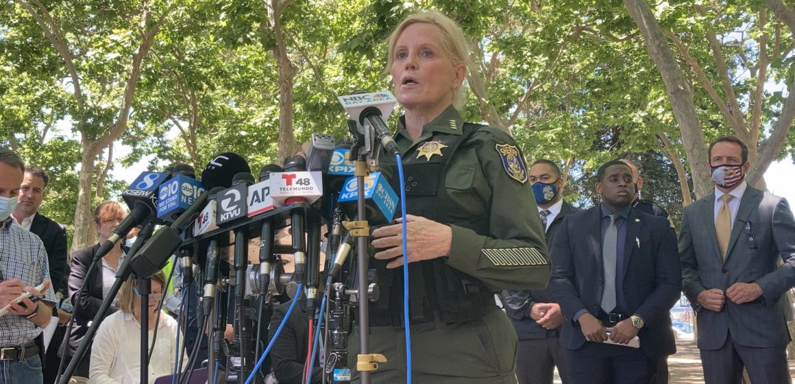 The former sheriff of Santa Clara County, Laurie Smith, speaks into microphones at a press conference after the VTA mass shooting on May 26, 2021.