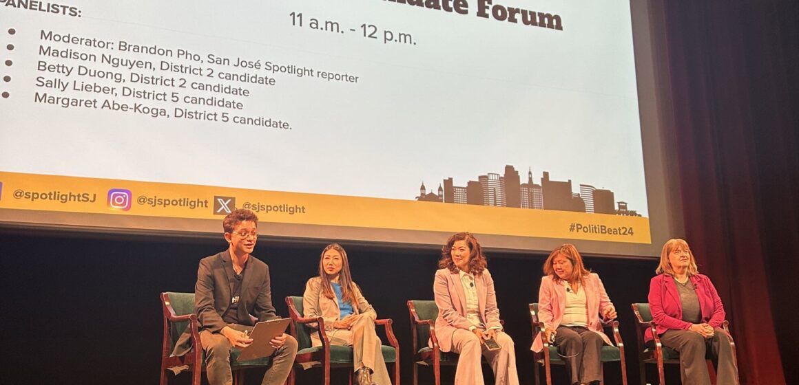 Five people on a stage during an election candidate forum