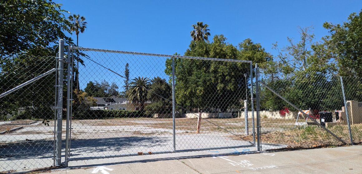 An empty, abandoned parking lot where a senior affordable housing development will go.