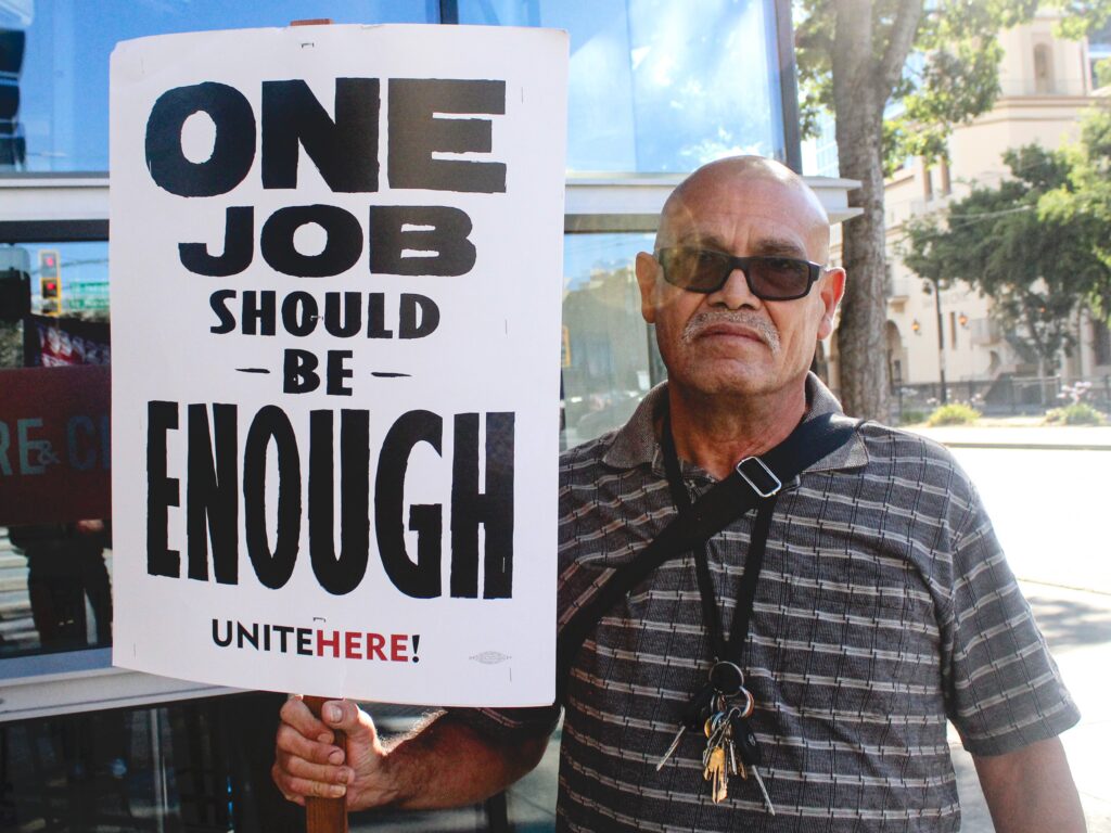 Hotel worker Jorge Zamudio marches with Unite Here Local 19 Tuesday evening in Downtown San Jose.